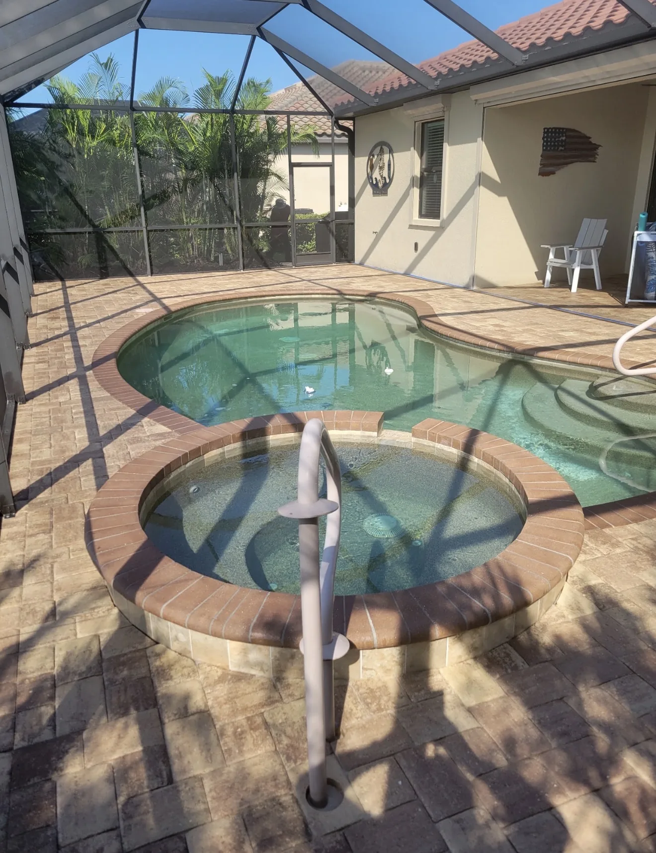 Sealed paver pool deck and spa beside the covered lanai in Venice, FL, after paver restoration