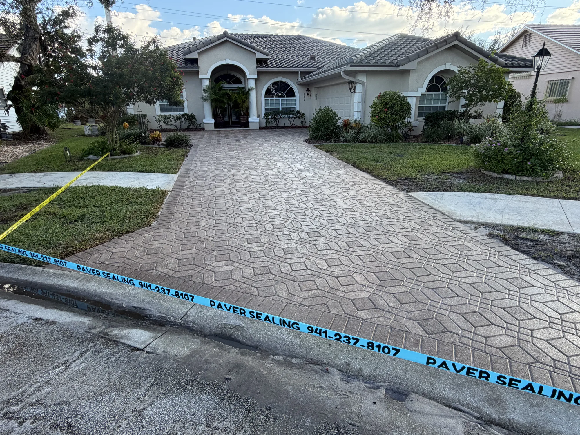 Paver driveway in Venice, FL after paver strip and restoration, even color and fresh sealer