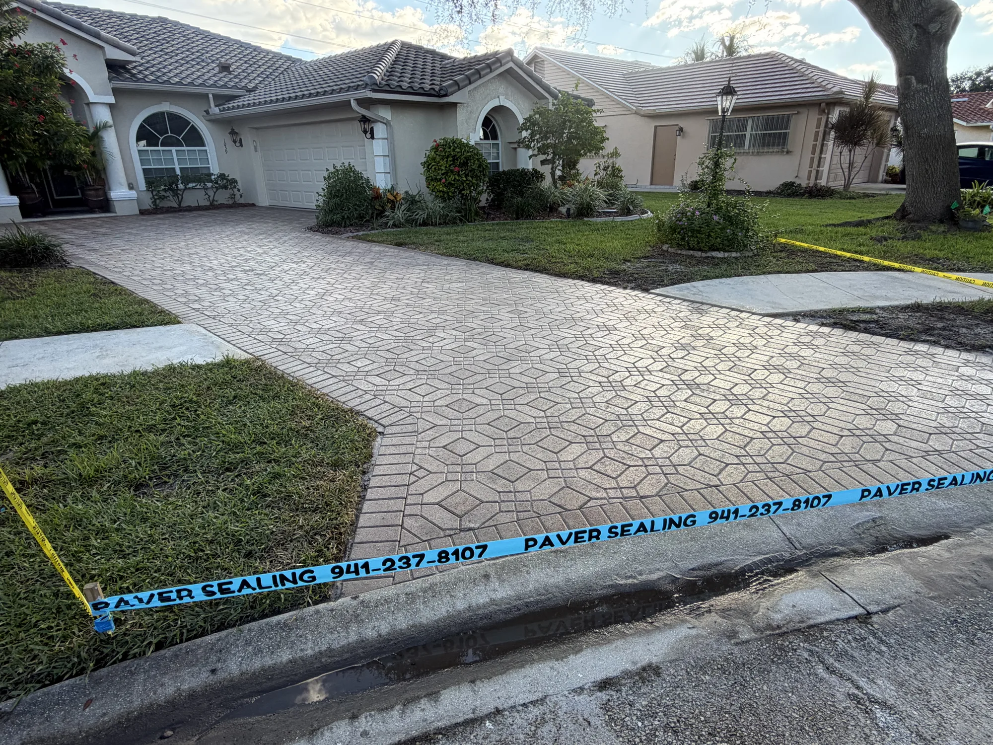 Restored paver driveway and walkway in front of the garage in Venice, FL after three coats of sealer